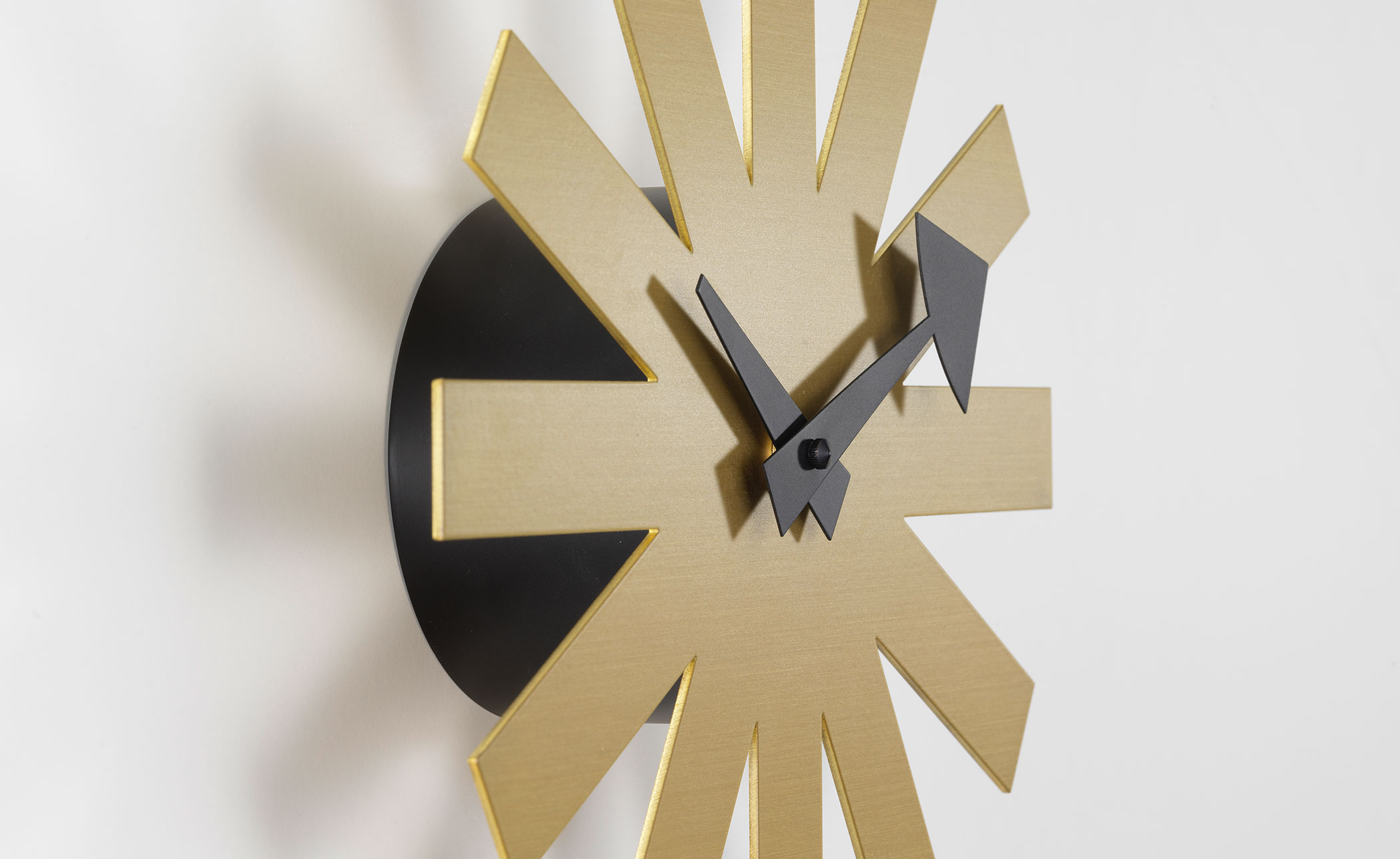 george nelson asterisk clock brass